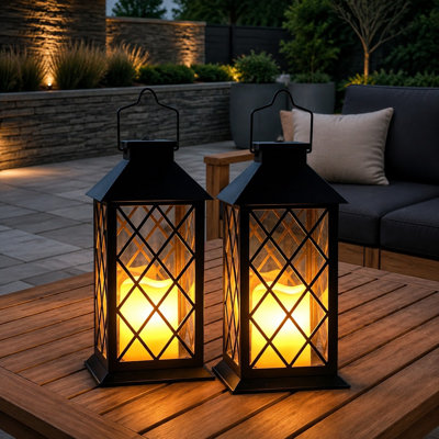 Two 14'' large black retro solar lanterns pair waterproof construction with tempered glass and flickering flameless candles, making the 2 Pack suitable for walls, porches, patios, tables, and gardens. For outdoor use.