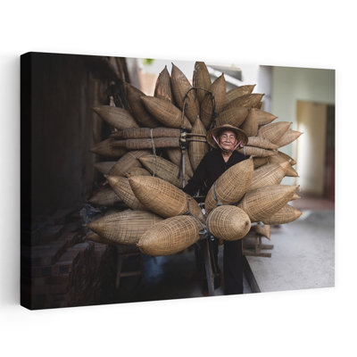 Femme souriante transportant des paniers, art traditionnel de poissons en bambou