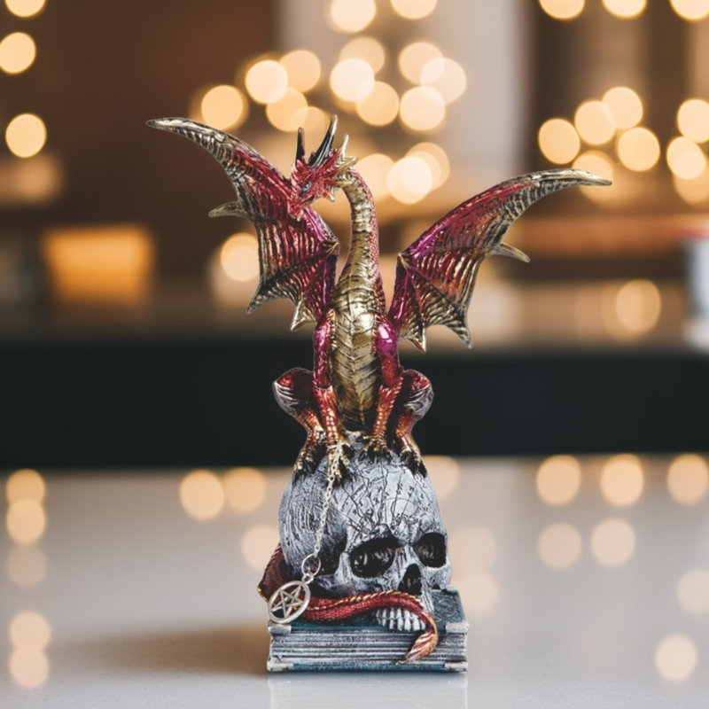 Figurine 9,25 po de dragon sur un crâne et un livre