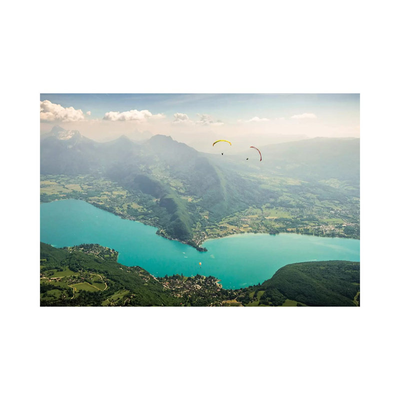 Two Paragliding Pilots Above The Annecy Lake, Haute Savoie, France by Alex Buisse - Wrapped Canvas Print