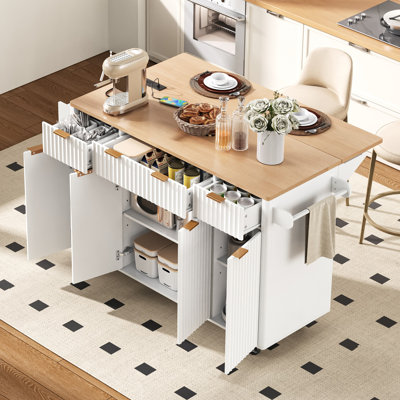 Fluted Kitchen Island with Storage, 55.5" Kitchen Island with Drop Leaf, Power Outlet, 4 Doors and 3 Drawers, Rolling Island Table with Wood-grain Top, Curved Edge for Kitchen,Dining Room White