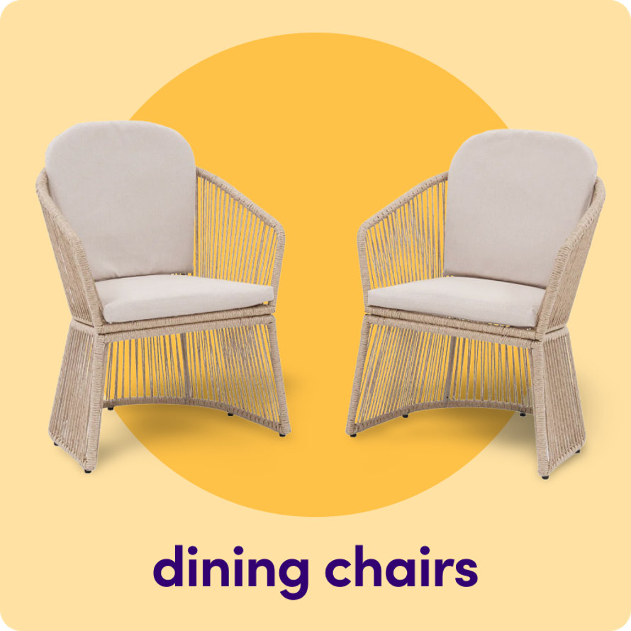 A pair of tan woven outdoor dining chairs with white seat and back cushions on a yellow circular background.