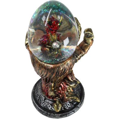 Main rouge griffe de dragon volcanique tenant un globe d'eau de bébé dragon