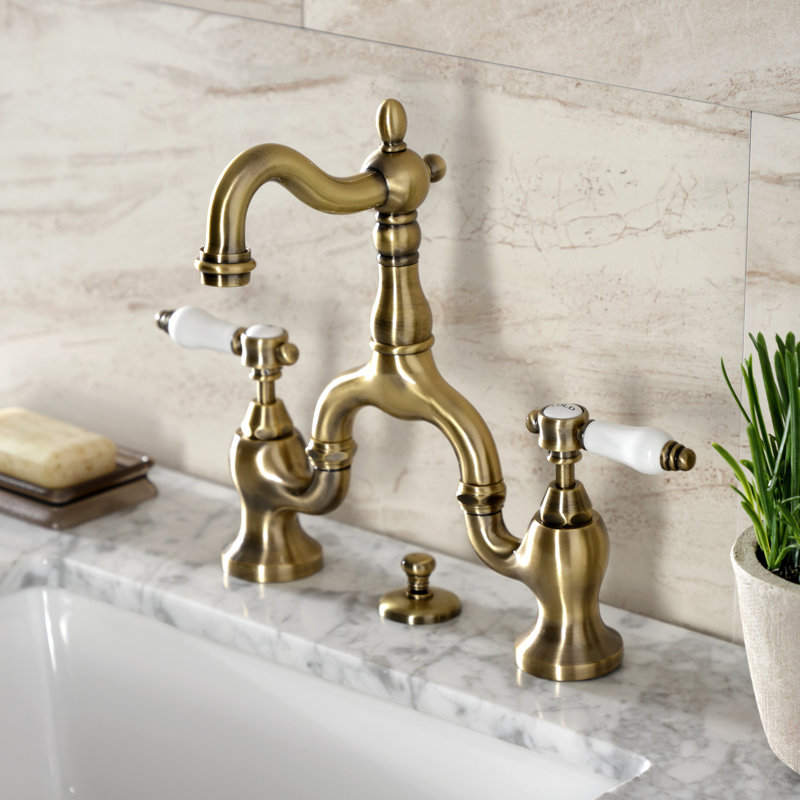 Kingston Brass Bel-Air Two-Handle 3-Hole Deck Mount Bridge Bathroom Faucet with Brass Pop-Up, Antique Brass