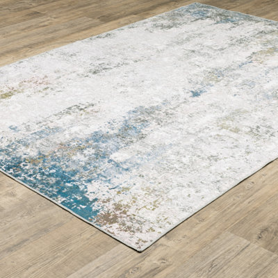 5' X 7' Ivory Teal Blue Abstract Printed Stain Resistant Non Skid Area Rug