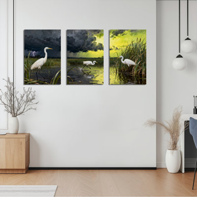 Ensemble de 3 tableaux sur toile tendue représentant un héron blanc dans un paysage marécageux