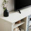 Meuble télé en imitation pierre, blanc, compatible avec les téléviseurs de 75 pouces, offrant un grand espace de rangement, console périphérique, pouvant accueillir des téléviseurs et des appareils électroniques.