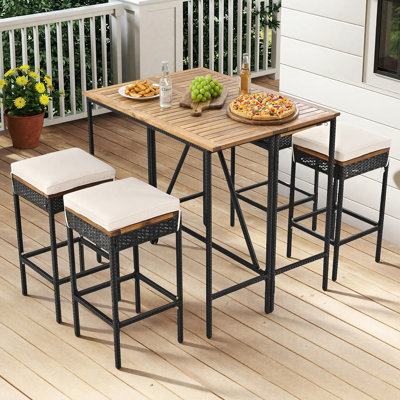 Ensemble 5 pièces de table de bar pliable en bois massif avec 4 tabourets et coussins moelleux, ensemble de bistro en osier de rotin PE