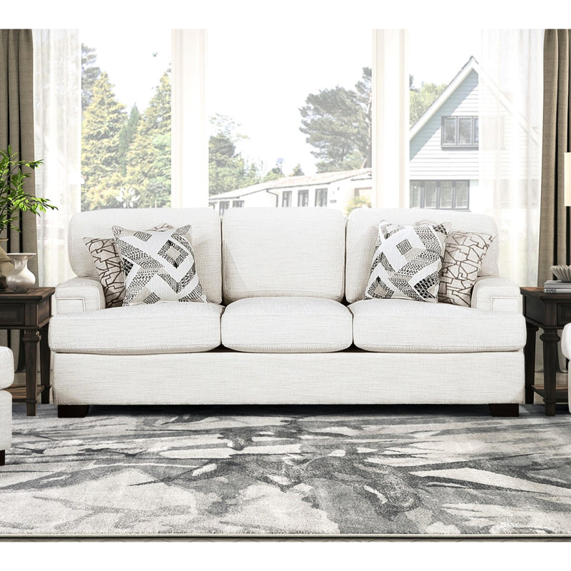 Tissu de luxe en chenille crème avec fabrication en bois massif et coussins réversibles pour une polyvalence avec rembourrage en mousse des pieds rembourrés