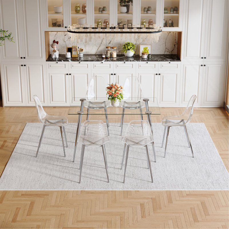 Ensemble de table et de chaises. Ensemble de table de salle à manger moderne et luxueux en verre trempé rectangulaire avec 6 chaises en plastique transparent avec pieds en métal argenté. Apportez une expérience de maison confortable à la cuisine.