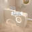Casual and minimalist cream-coloured checkout counter with a curved design and baked paint finish-655154134