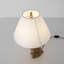 Lampe de table chiot en résine moderne avec abat-jour en tissu beige, finition or antique