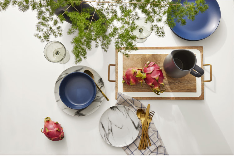 stylish flat lay with dinnerware, serveware, and drinking glasses