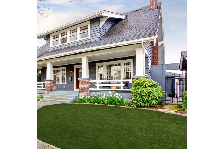 large gray house with a picturesque front yard