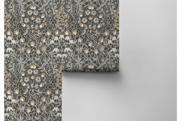Floral pre-pasted wallpaper roll being applied to a white wall.