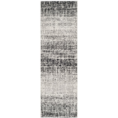 Riebe Black Area Rug