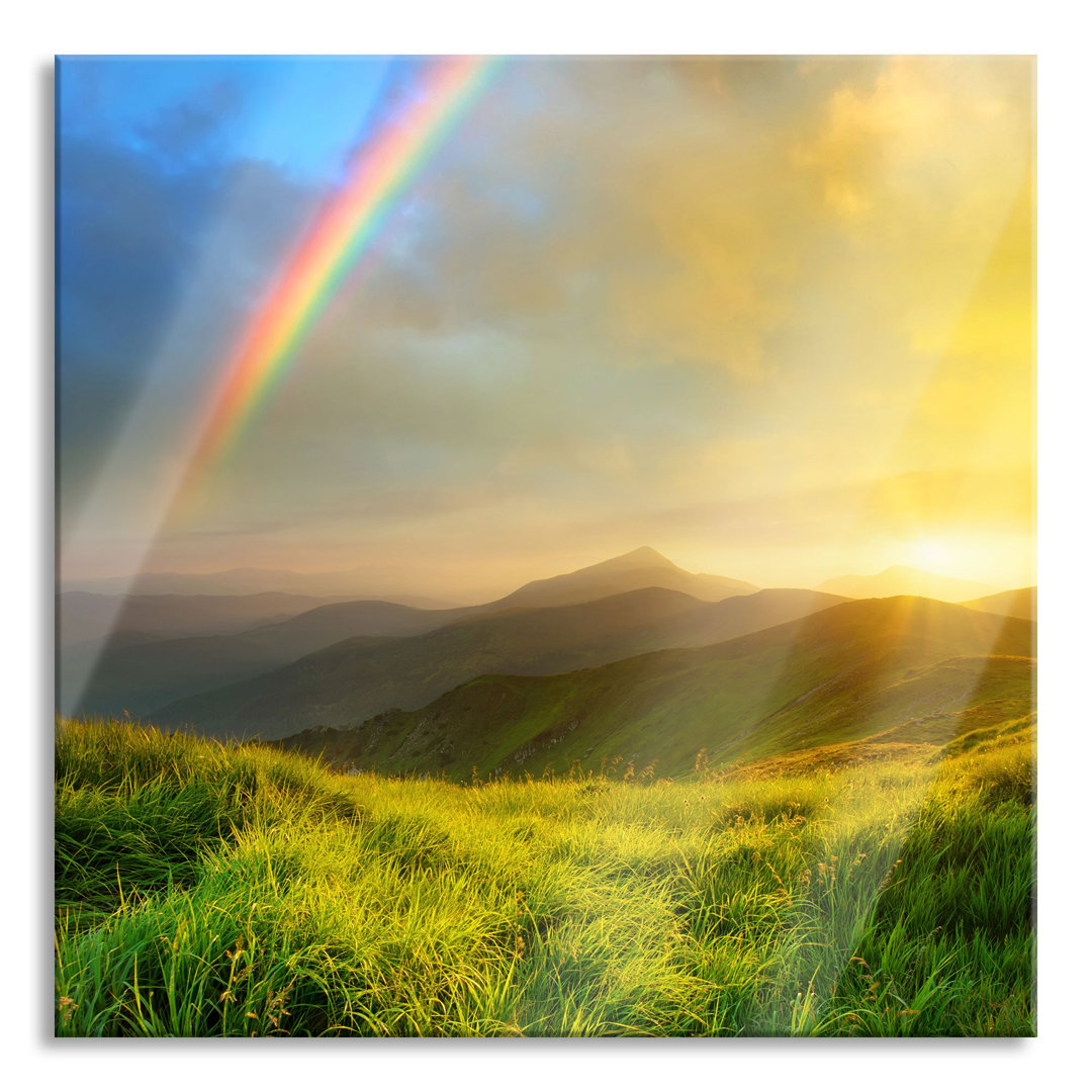 Glasbild Berge mit Regenbogen am Himmel