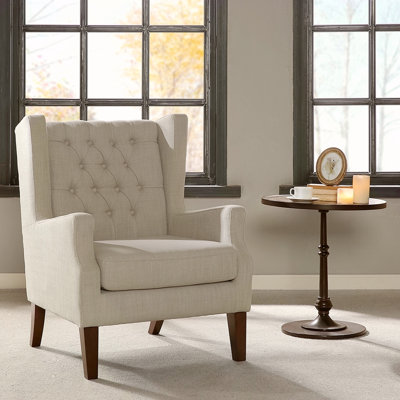 Fauteuil à oreilles capitonné
