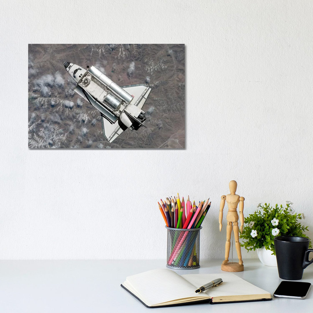 Aerial View Of Space Shuttle Discovery Over Earth As It Approaches The International Space Station by Stocktrek Images - Wrapped Canvas Print