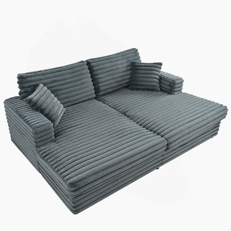 Très grand canapé-lit avec méridienne et coussins décoratifs en velours côtelé moelleux pour une détente confortable dans le salon