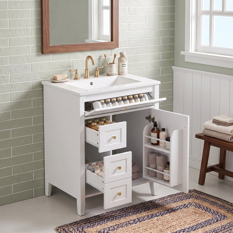Meuble-lavabo autoportant en MDF blanc de 61 cm (24 po) avec lavabo en céramique, poignées en métal, porte à fermeture amortie et tablette de rangement.