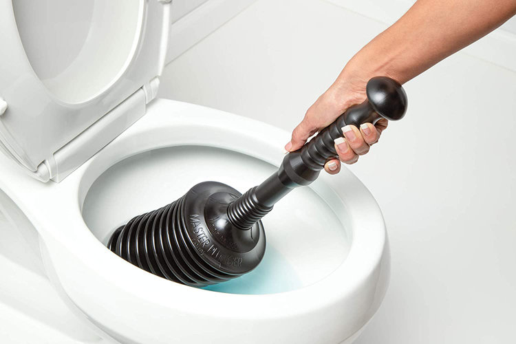 A close-up shot of a plunger effectively unclogging a toilet.