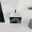 Meuble-lavabo mural 24 po. Contreplaqué noir avec porte à fermeture en douceur. Évier en céramique pour une salle de bain moderne.