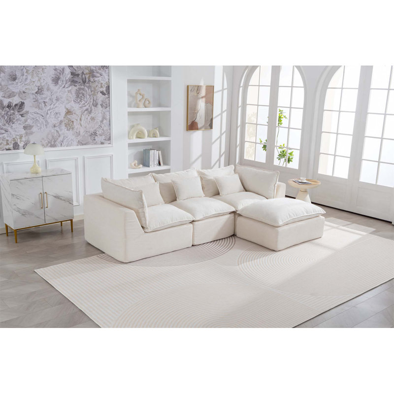 Canapé modulaire surdimensionné surdimensionné avec assise large et profonde, véritable design de relaxation, comprenant un repose-pieds, idéal pour le confort d'un salon spacieux et une configuration flexible.