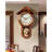 Vintage solid wood wall clock with a roof-shaped top and a metal pendulum