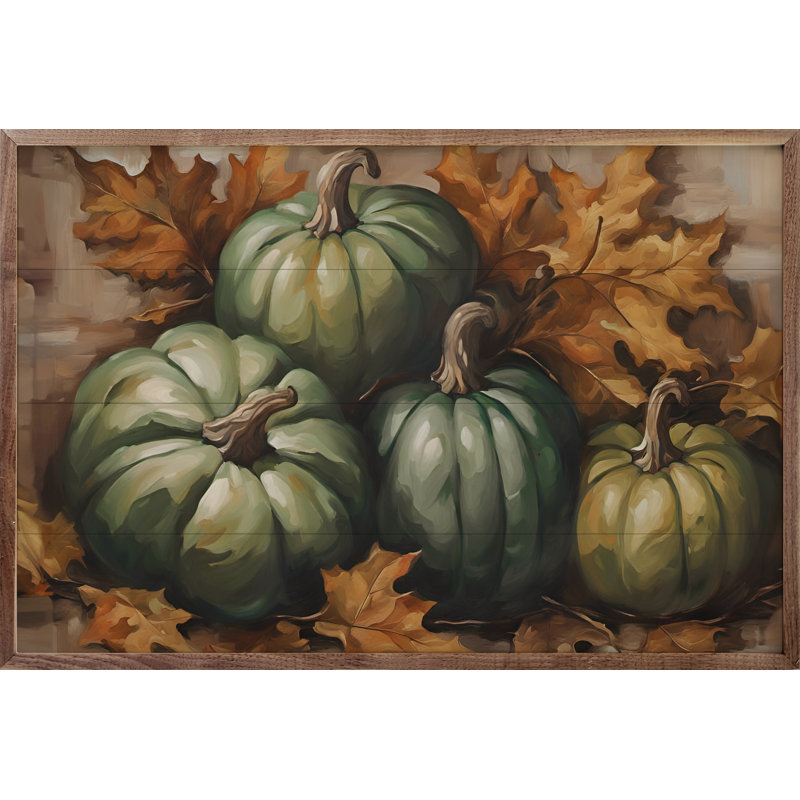 Quatre citrouilles vertes en feuilles