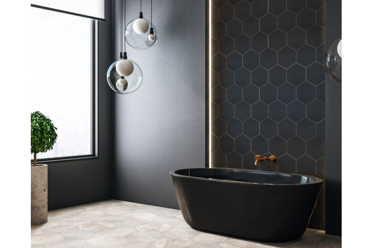 Black moody bathroom with a black tub. Large glass globe lamps in front of a large frosted window