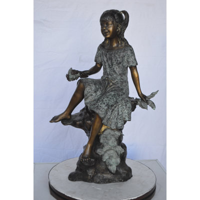 Maude Girl on Tree Trunk Holding Flowers Bronze Statue -  Size: 26"L x 11"W x 36"H.