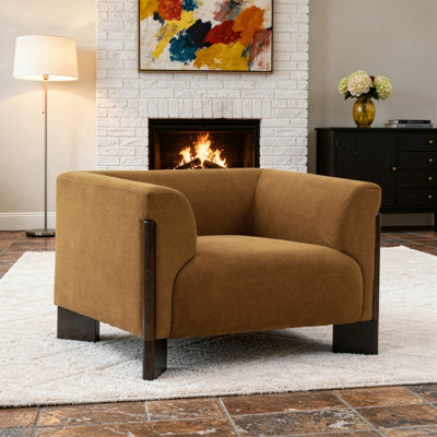 Fauteuil rembourré moderne en velours orange avec accoudoirs courbés et pieds en bois massif