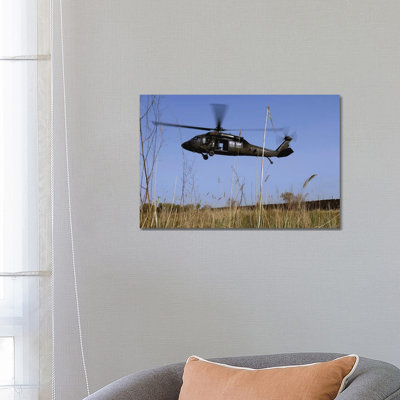 A US Army UH-60 Black Hawk Helicopter Prepares To Pick Up Soldiers by Stocktrek Images - Wrapped Canvas Gallery-Wrapped Canvas Giclée