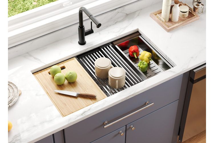 durable kitchen sink materials stainless steel kitchen sink a white marble countertop and blue cabinets