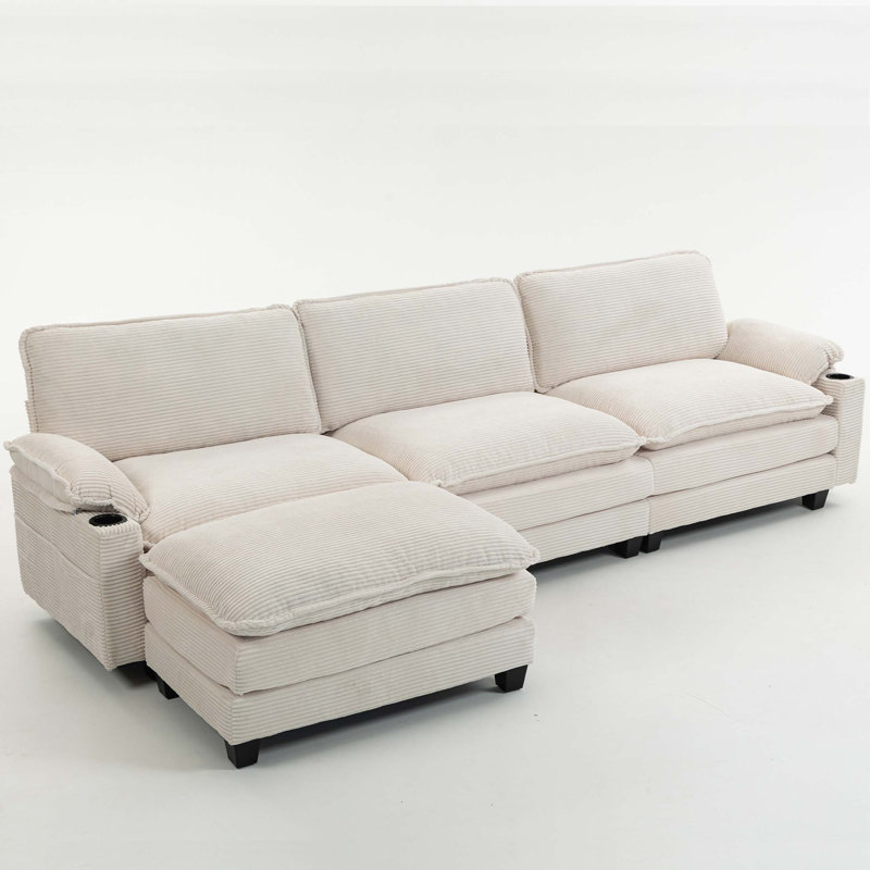 113" Modern 3+1 L-Shaped Corduroy Fabric Sofa,Modular Sectional Cloud Couch W/Ottoman,35D High-resilience Sponge&Double-layer Thick Cushion,Cup Holders,Storage Bags