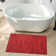 Ellicia Solid Color Polyester Area Rug in Red/Orange