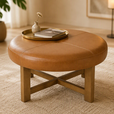 Table basse ronde avec repose-pieds en cuir et base en bois massif, repose-pieds capitonné en similicuir, plateau brun avec pieds au fini noyer
