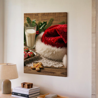 Canvas A Cozy Festive Tabletop Scene Set During The Holiday Season Wall Art Featuring A Vibrant Red Santa Hat With A Fluffy White For Canvas Wall Art