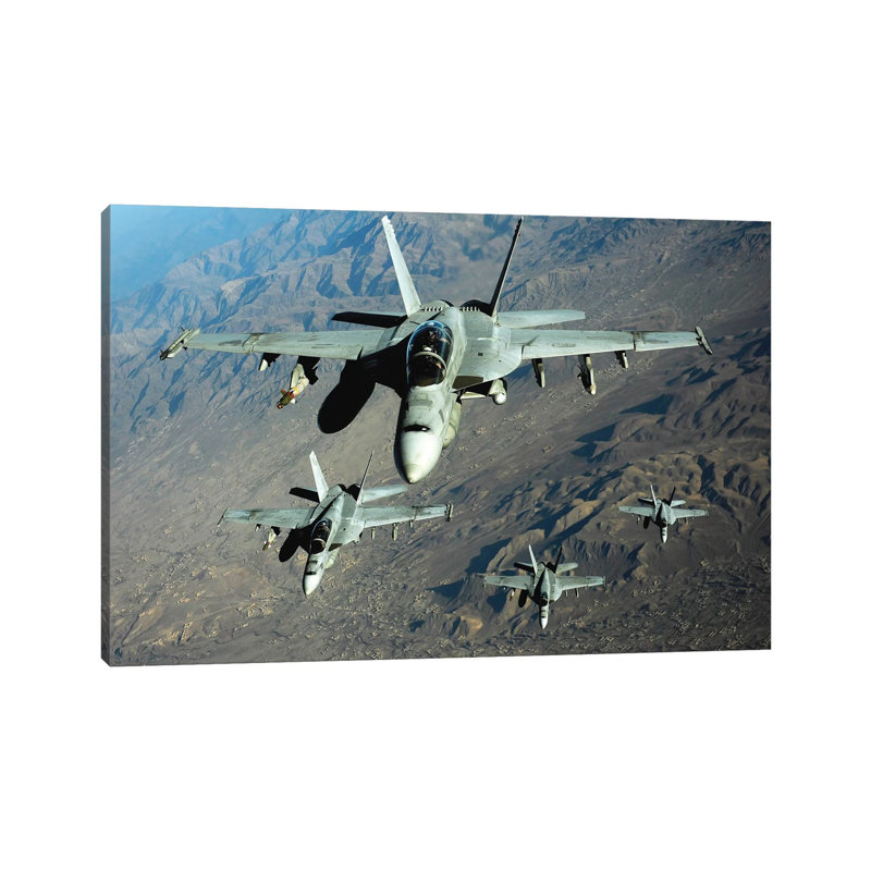 Four US Navy F/A-18 Hornet Aircraft Fly Over Mountains In Afghanistan by Stocktrek Images - Wrapped Canvas Print