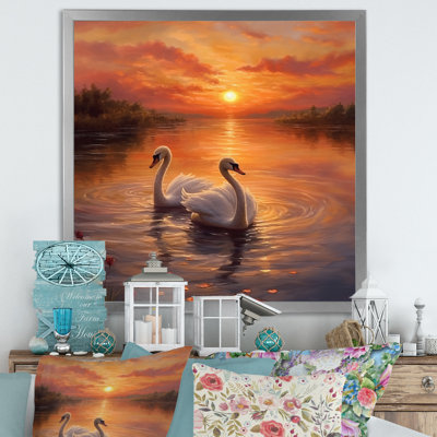 Coucher de soleil romantique avec deux cygnes blancs