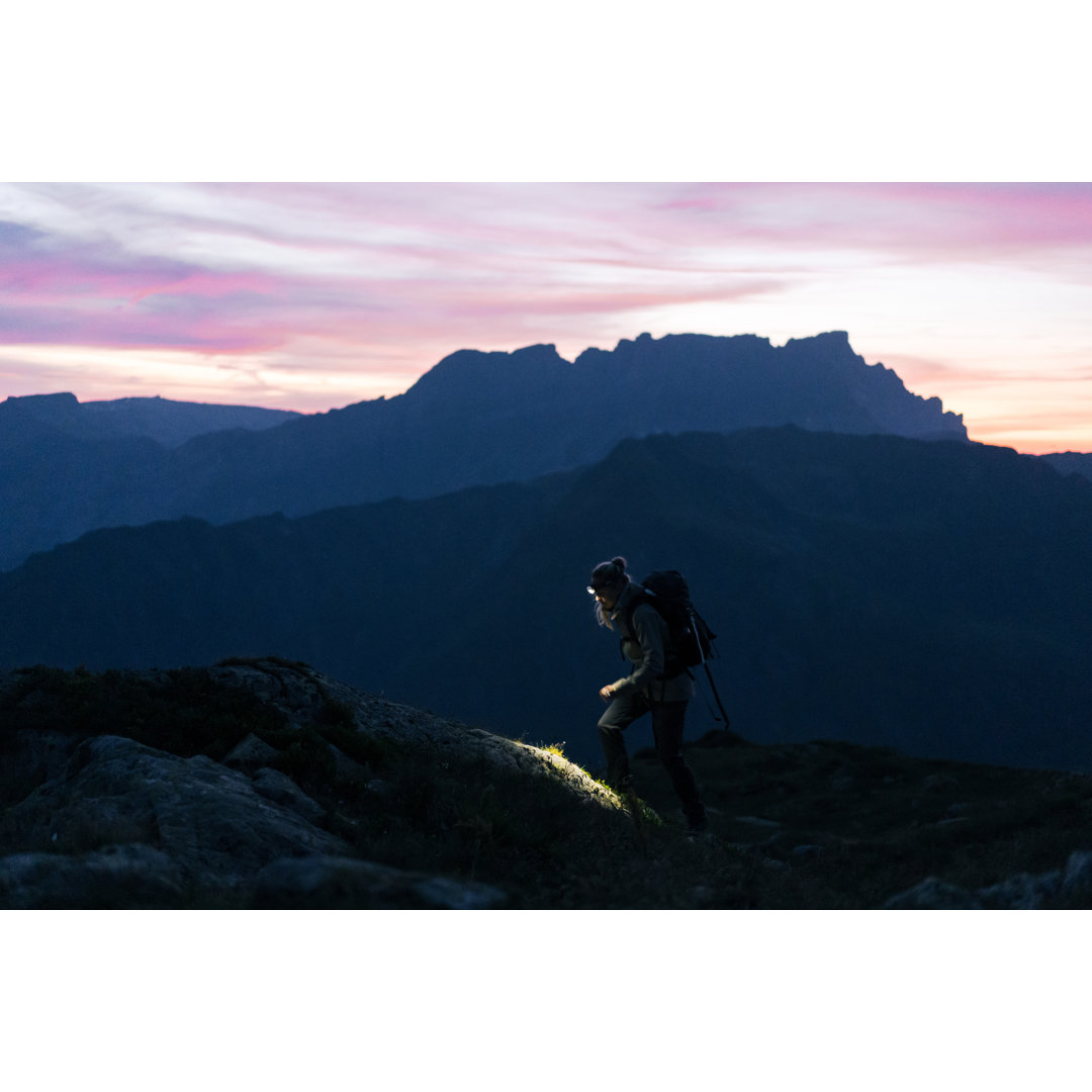 Wanderin überquert Bergkamm by AscentXmedia - Leinwandbild