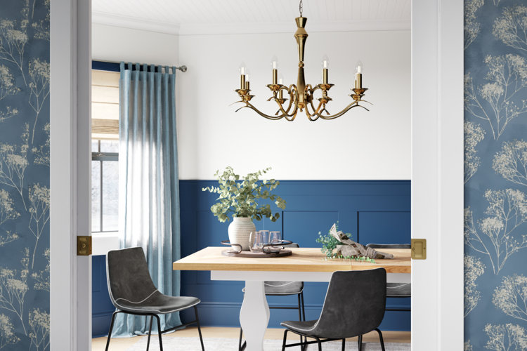 gold candle-style chandelier above a wood dining table