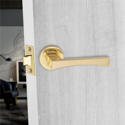  Wave Handles Set on Round Rose in Electro Brass Finish with 64mm 3 Lever Mortise Lock and Key Hole