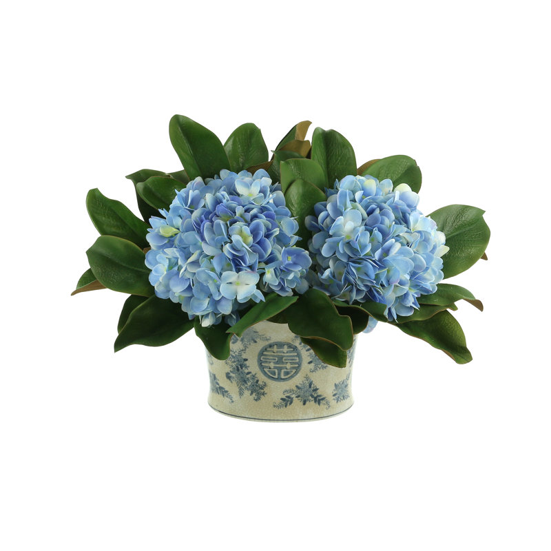 Hydrangea And Magnolia Leaf Arrangement In A Decorative Ceramic Pot