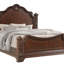 Grand lit de style traditionnel avec sculptures en bois complexes, finition noyer riche et tête et pied de lit élégants