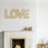 «Love» - Sculpture murale dimensionnelle en fer noire et dorée Family