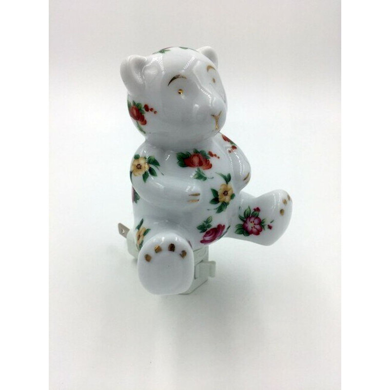 Fleurs sur une veilleuse en forme d'ours en peluche
