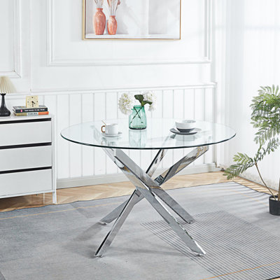Table de salle à manger ronde avec pieds croisés en métal et plateau en verre