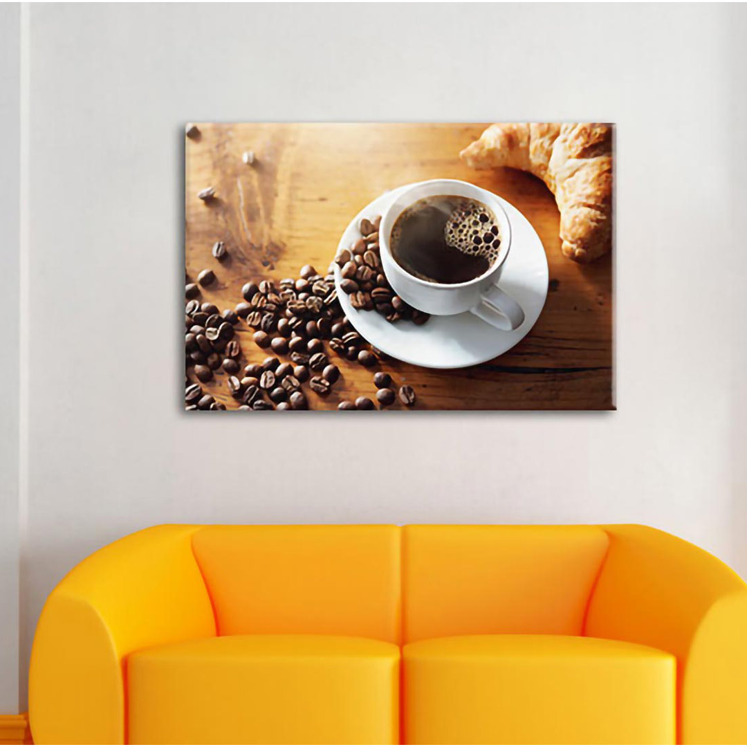 Leinwandbild Tasse Kaffee mit Bohnen und Croissant